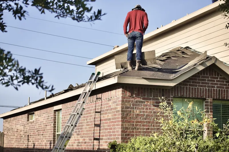 Professional roofer working on a residential roof in Andersen Springs